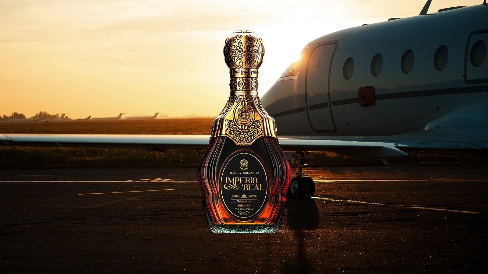 Imperio Real Extra Añejo tequila bottle with ornate gold background